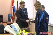 The mayor hands Vladislav the tablet