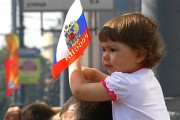 A young child waving a flag