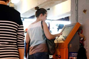 Woman uses a top-up terminal in Moscow