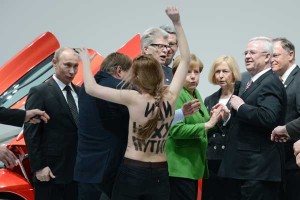 Putin looks a naked member of Femen in the... eye?