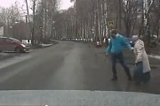 A kind man helps an older lady cross the road