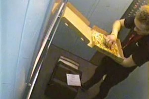 Pizza delivery man eats topping
